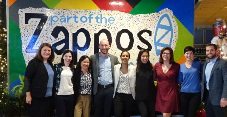 EAB staff members in front of Zappos sign