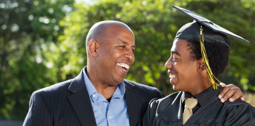Smiling African American Student in Cap and Gown with Parent