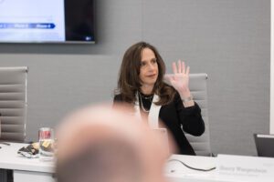 Chief business officer raising hand in meeting room