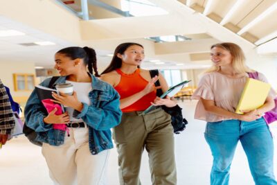 A group of students walking through the halls of their university campus.